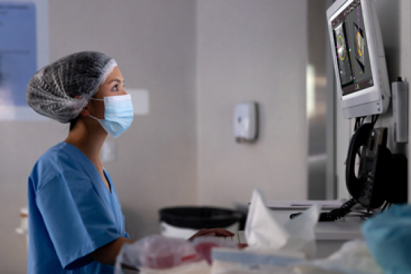 Health care professional looking at display in a lab setting